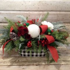 Christmas Floral arrangment with winter greens red and white flowers with a buffalo plaid tin container
